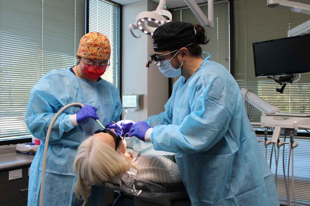 Dr. Mancin and team performing wisdom teeth removal surgery in Overland Park, KS