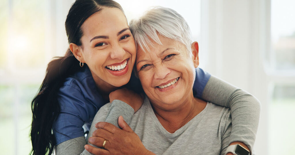 Adult daughter helping her older parent afford dental implants at OP Implant Dental in Overland Park, KS