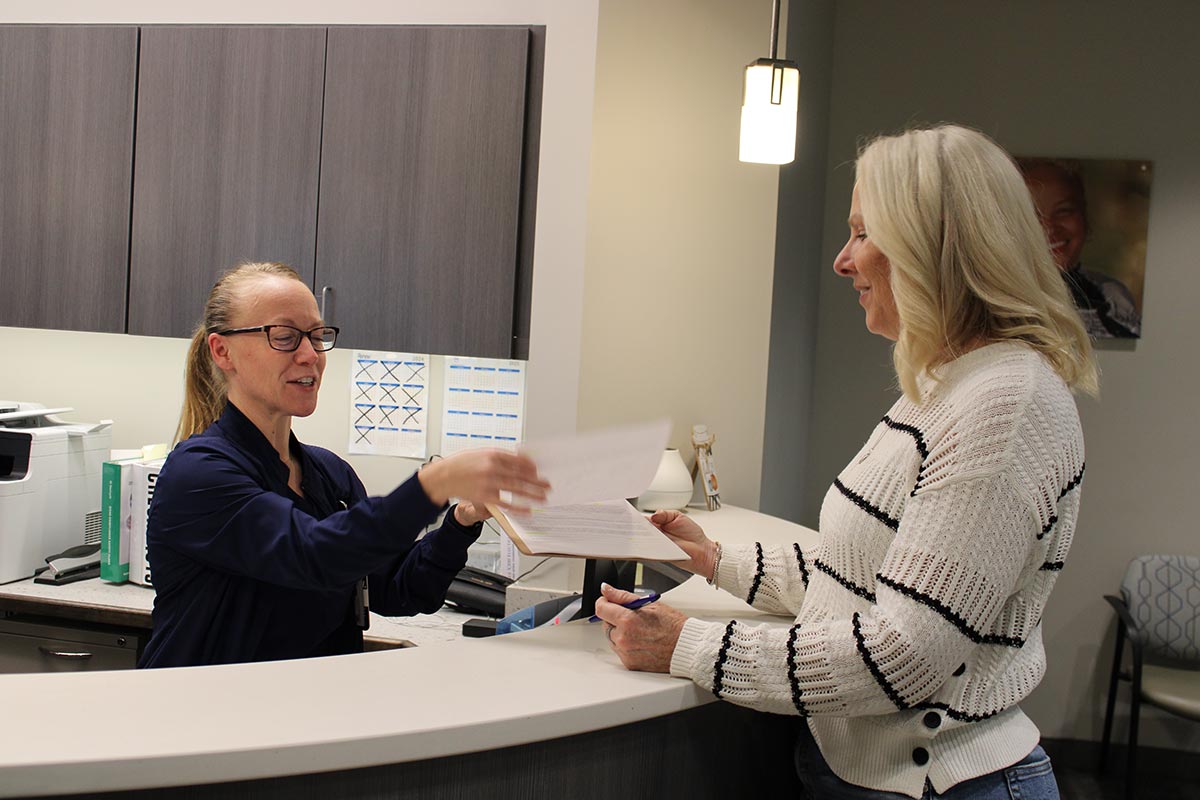 Insurance Check-In at OP Implant Dental New patient checking in with insurance card at OP Implant Dental in Overland Park
